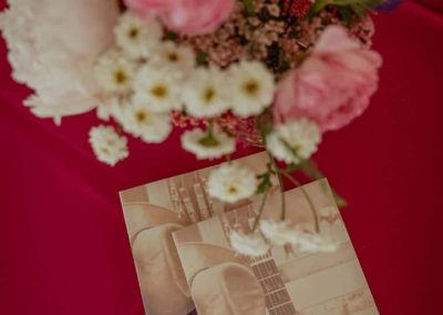 Beautiful wildflowers and roses adorn a table top with Songwriter Shuffle program.