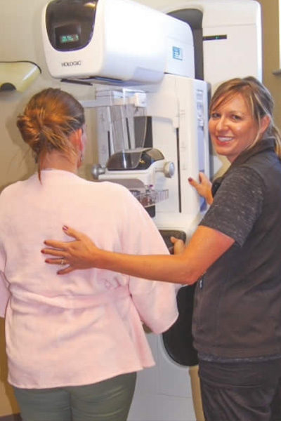 Mammogram at GVH A patient and technician at a breast screening exam.