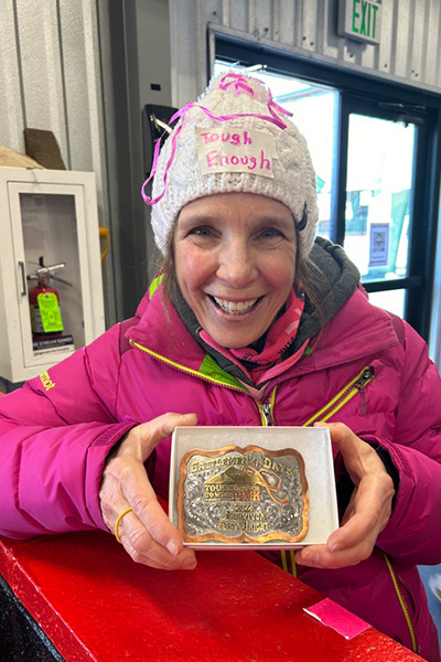 Tough Enough Survivor GT cancer survivor of the year shows off her buckle at Pink in the Rink.