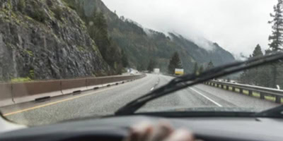 Looking through a windshield of one of GT's vehicles at a stormy interstate highway.