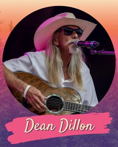 Dean Dillon playing a guitar and singing into a microphone.