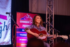 Pam Tillis serenades the audience with her guitar and lovely voice.